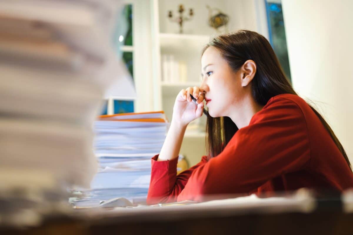 woman worrying about the deadline of her report at home. Workaholic people concept