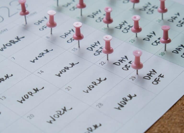 4 day work week printed calendar with pink pins on three days off in week weekend days four day working week concept. Modern approach doing business short workweek. Effectiveness of employees. Productivity and efficiency days off