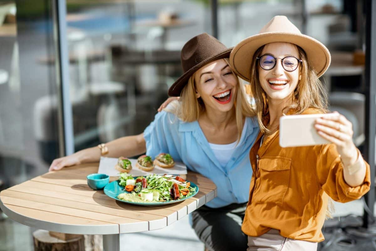 Girlfriends eating healthy food on a terrace