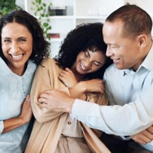 Mature parents, black family and daughter hug together on sofa for love, bonding and fun with happy