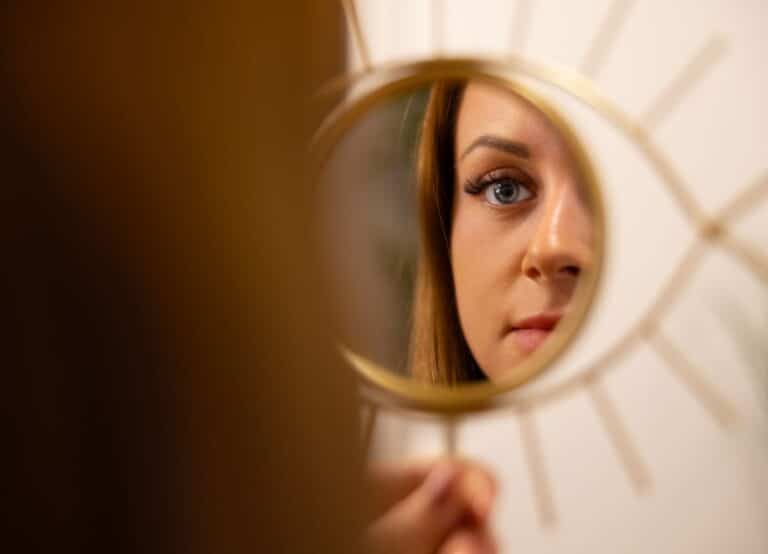 Young Woman Looking At Her Reflection