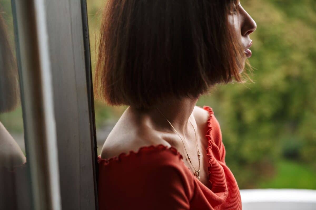 close up image of woman staring by the window