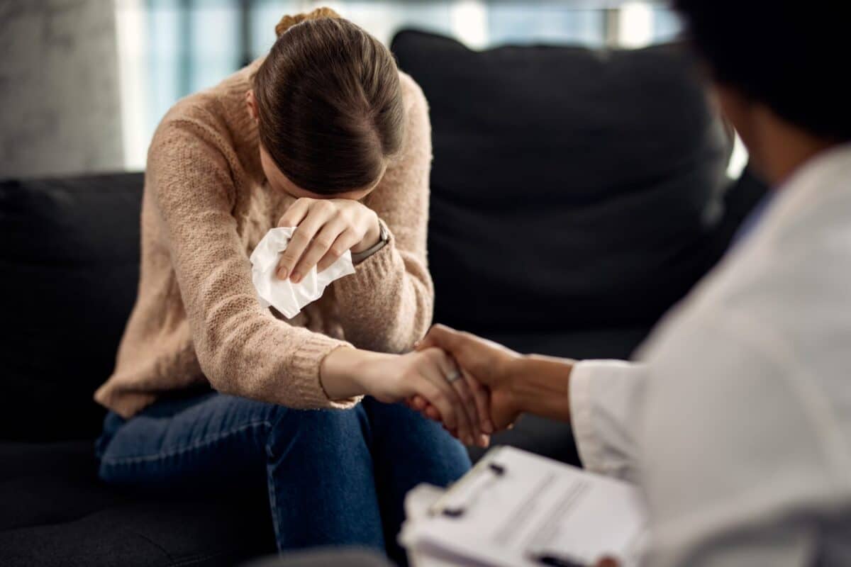 crying woman talking to a therapist, concept of grief