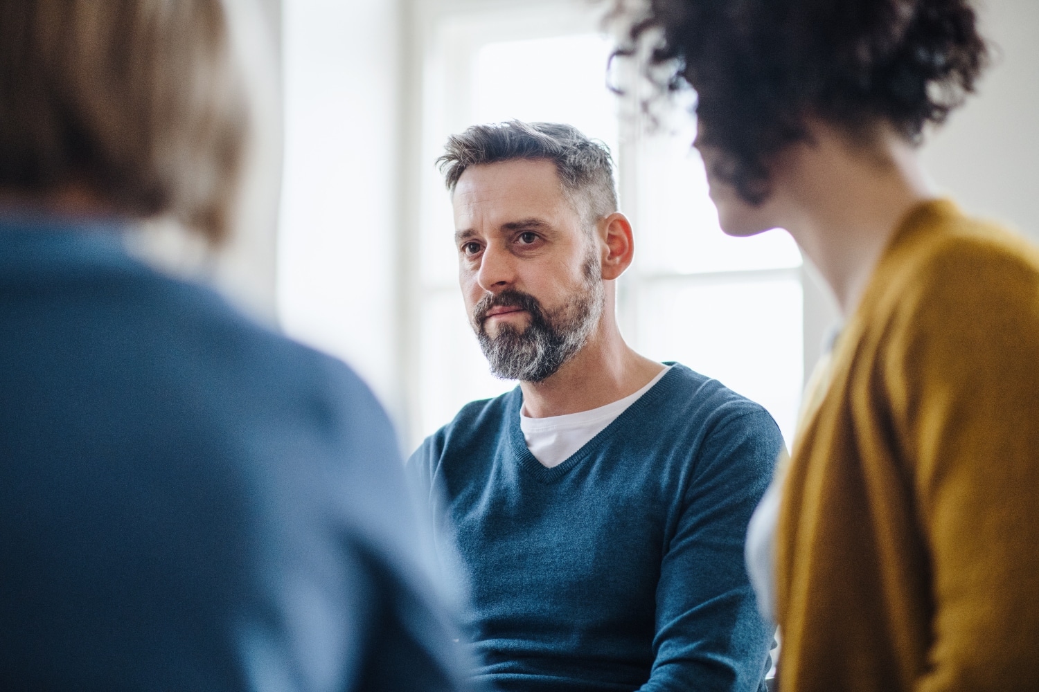 family members having a serious conversation at home, focus on adult man, concept of relationships