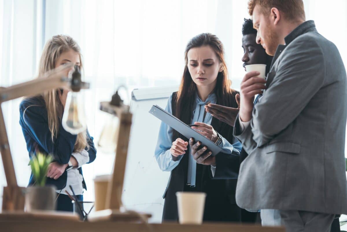 group of young businesspeople reviewing documents together