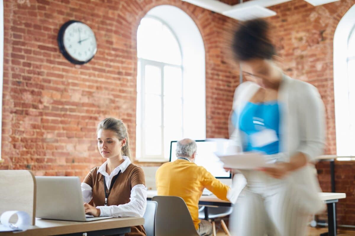 image of a woman in an open office space, concentrating on work