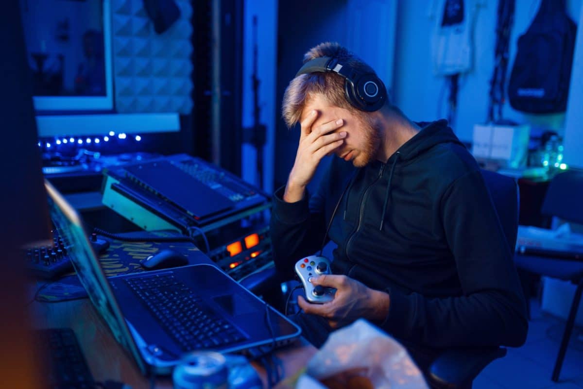 man almost sleeping while playing video game