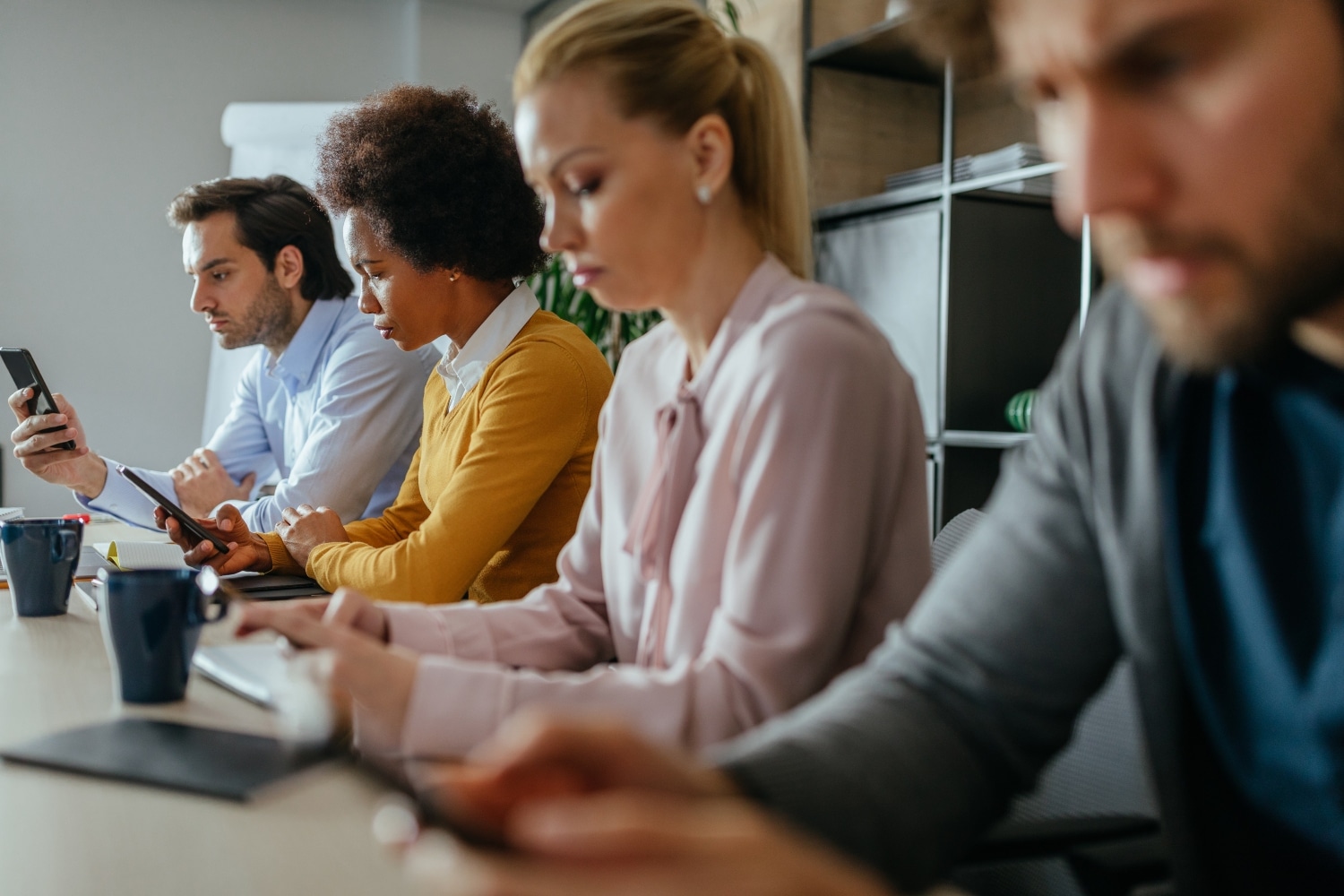 office employees sitting on an office table, concept of burnout, work culture