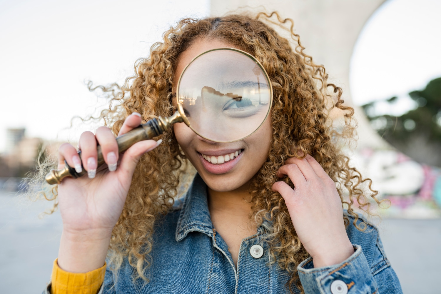 pretty young woman with a magnifying glass, concept of perfectionism