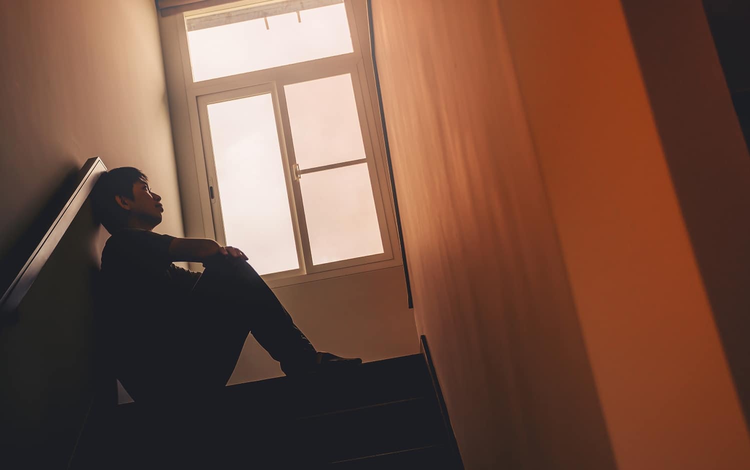 sitting alone by the stairs, concept of loneliness, solitude, mental health struggles