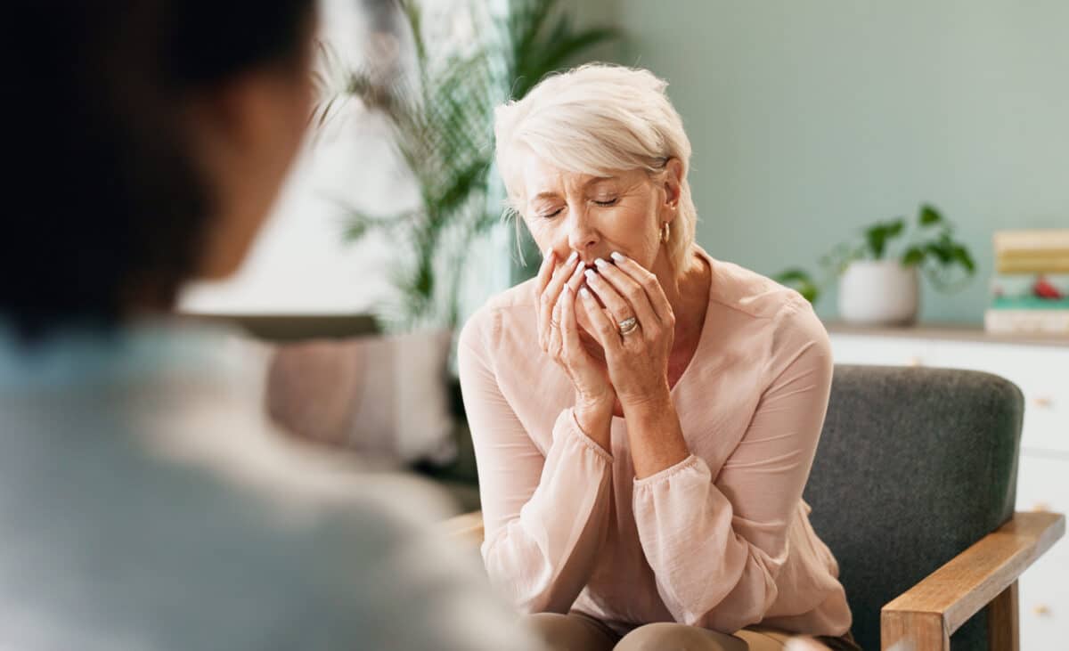 stress image of an old woman with psychologist in consultation for help, mind and mental health