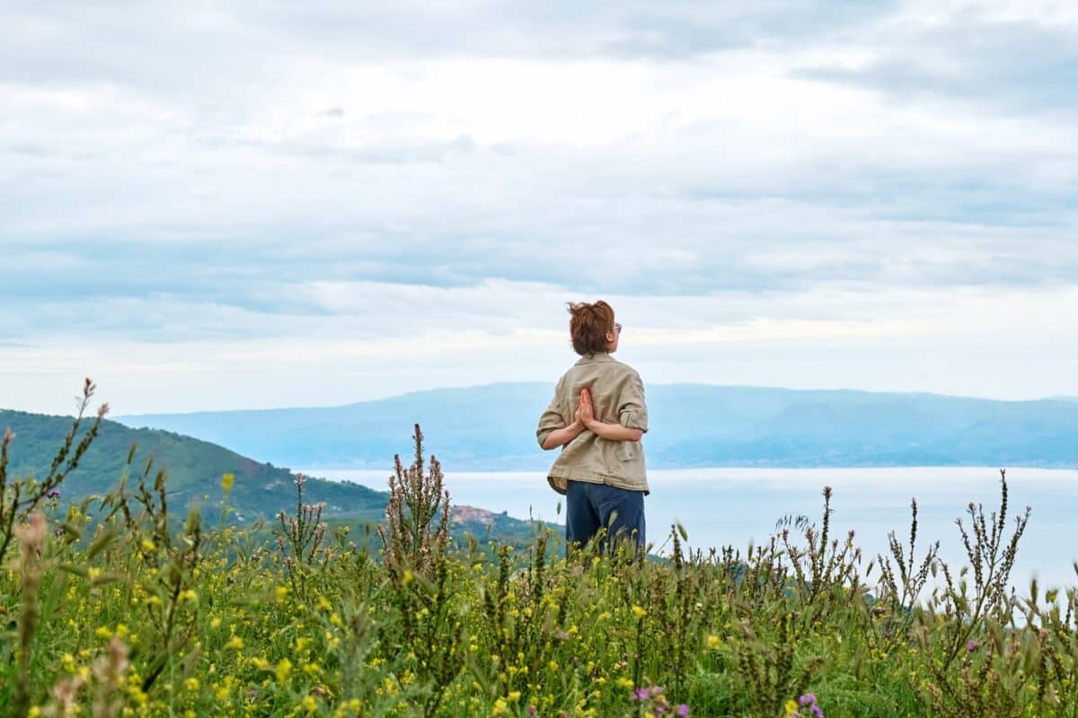 woman looking out into nature, concept of mindfulness, acceptance, inner peace