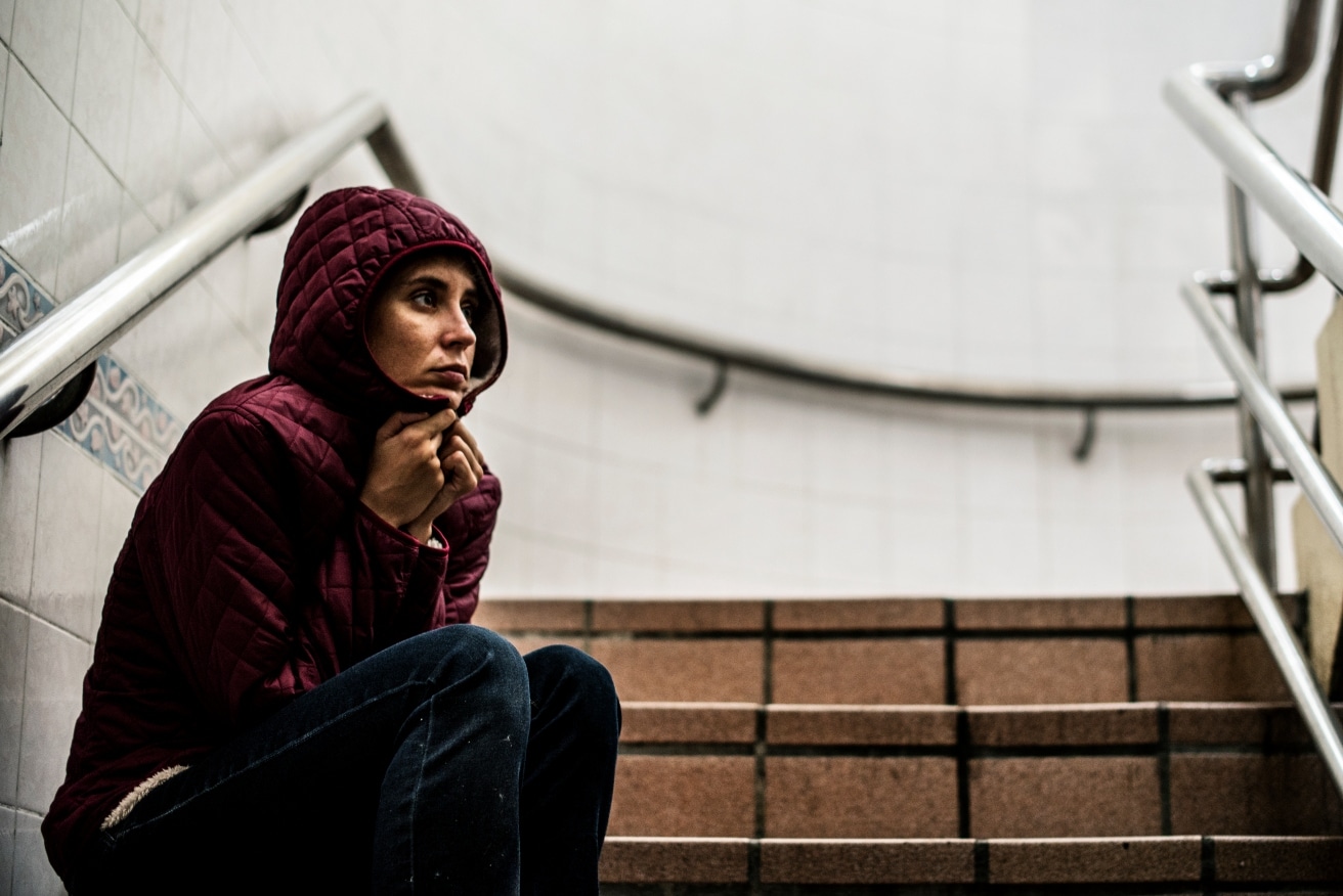 woman-sitting-by-the-stairwell-alone-and-looking-anxious-concept-of-depression-addiction