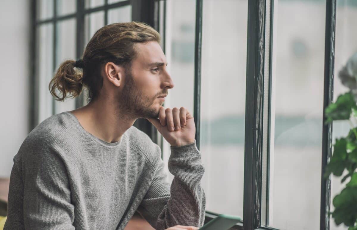 young man looking thoughtful, concept of self reflection and conscious thoughts